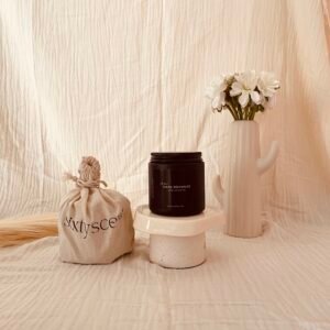 Dark Romance soy candle with an alluring blend of amber, oud, rose, passion fruit, bitter orange, and cinnamon — bold yet comforting aroma for intimate spaces