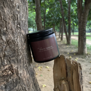 Mystic Woods soy candle with calming blend of amber, oudh, patchouli, and sandalwood for warm, earthy ambiance